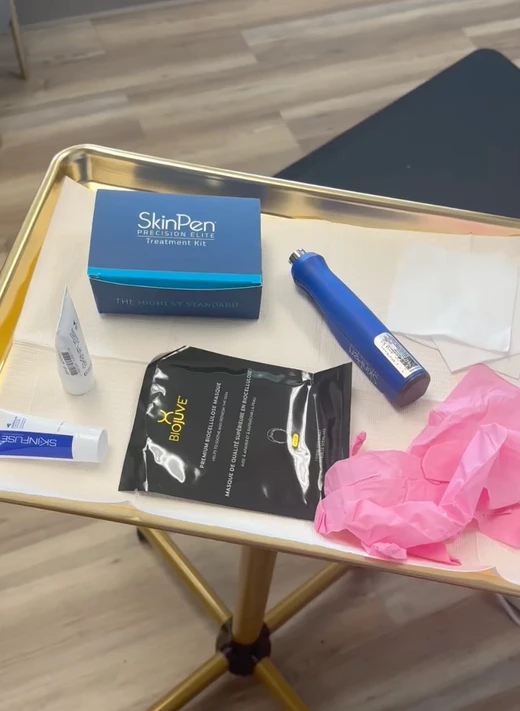 SkinPen microneedling pen and packaged treatment supplies on a gold tray